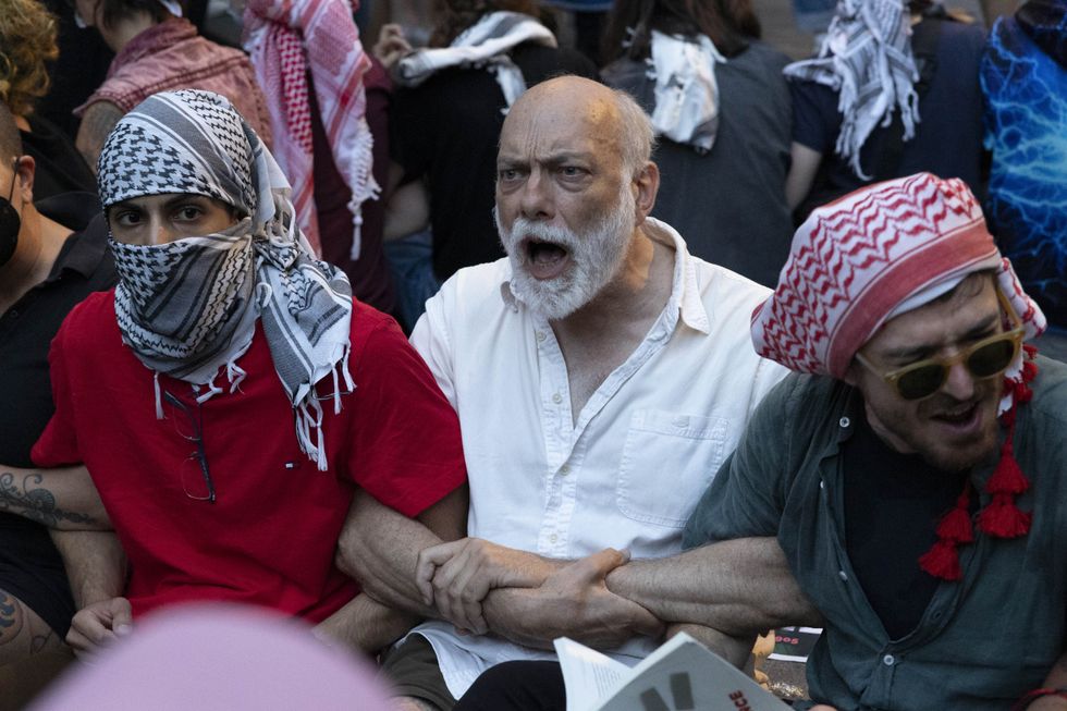 June 18, 2024, New York, New York, USA: Pro-Palestine climate justice demonstrators participate in an act of civil disobedience occupying the plaza outside of Citi's corporate headquarters to protest Citibank's investment in Israel. The protest is part of the Summer of Heat campaign against Wall Street's investment and insuring of fossil fuels. (Credit Image: © Gina M Randazzo/ZUMA Press Wire)