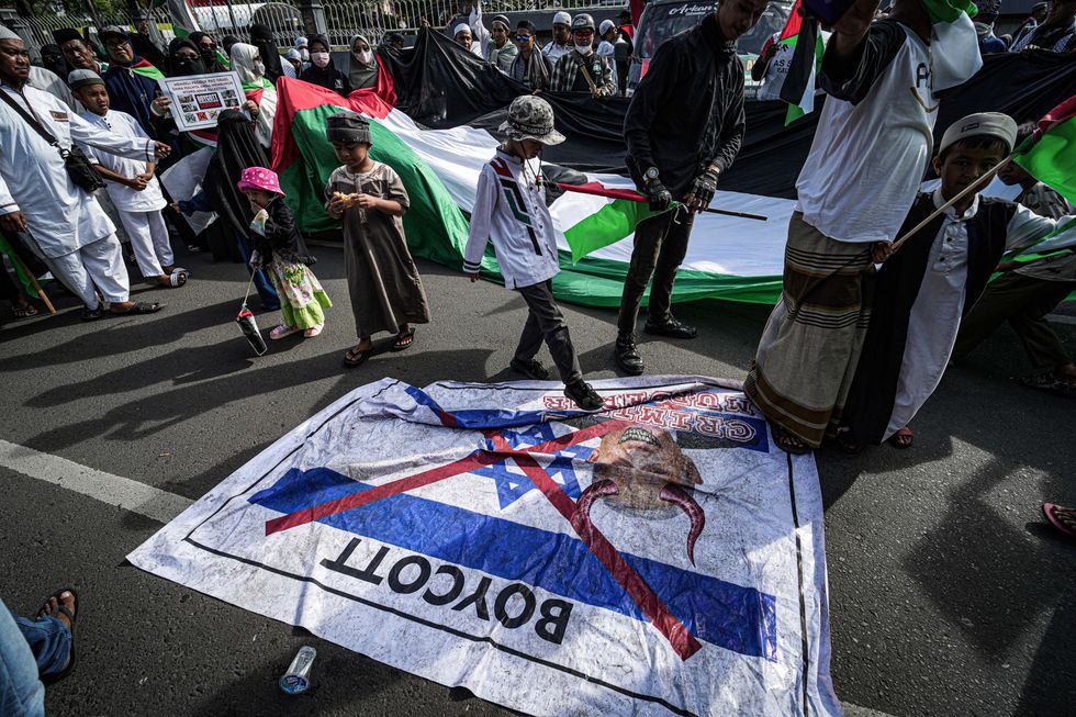 June 7, 2024, Makassar, South Sulawesi, Indonesia: A number of demonstrators stepped on banners depicting Israeli prime minister Benjamin Netanyahu in front of the Makassar Mandala Monument, as a form of support for the boycott of Israeli products. The action was carried out to ask the world to stop the genocide carried out by Israel against Palestinians (Credit Image: © Herwin Bahar/ZUMA Press Wire)