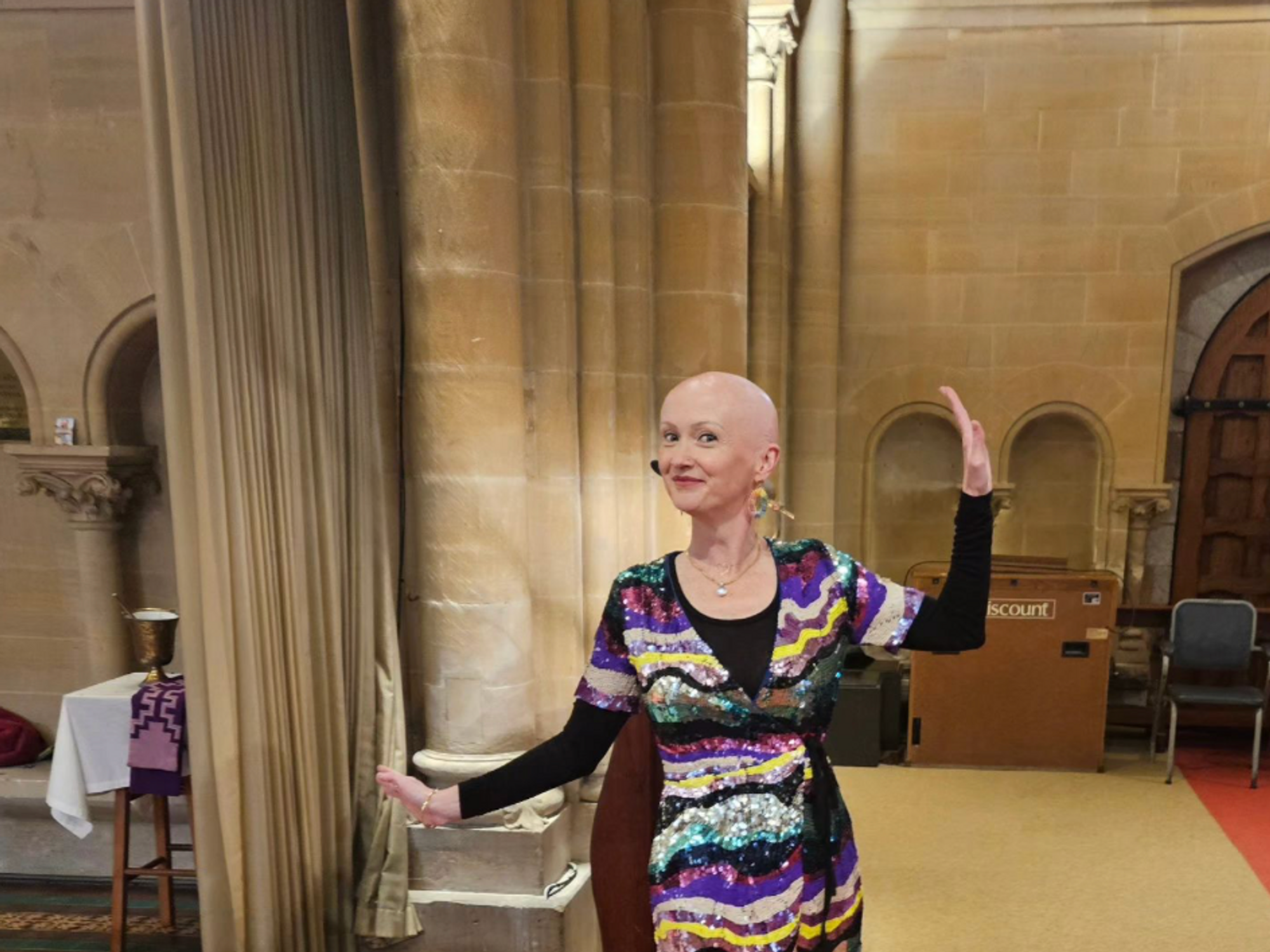 Karen Dempsey, the bald priestess, wears rainbows and sequins for a funeral.​