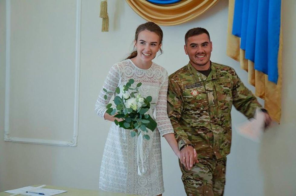 Kateryna and her husband at their wedding.