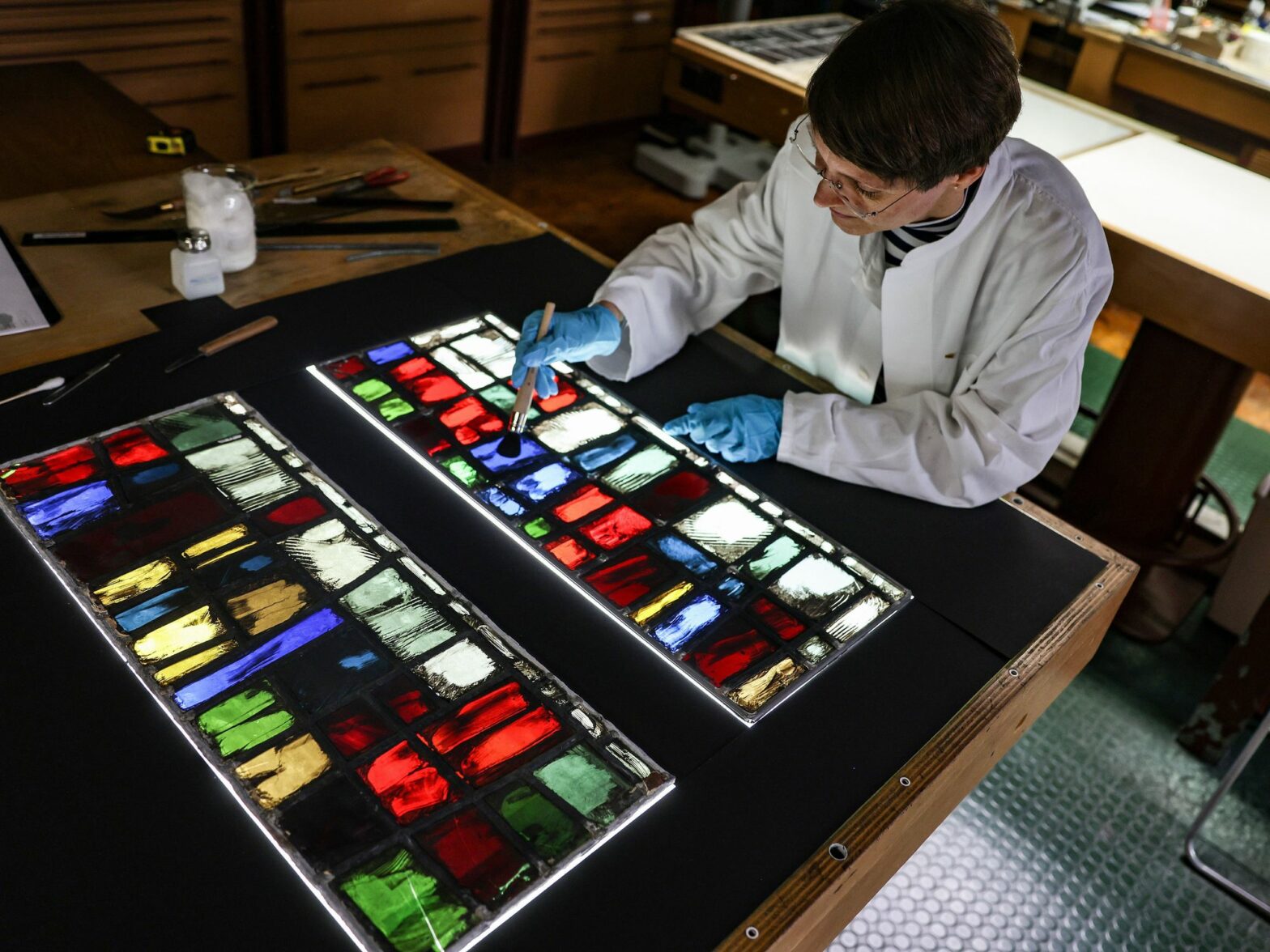 Katrin Wittstadt, scientific director of the glass workshop at the Dombauhütte, works on stained glass windows from Notre Dame Cathedral.