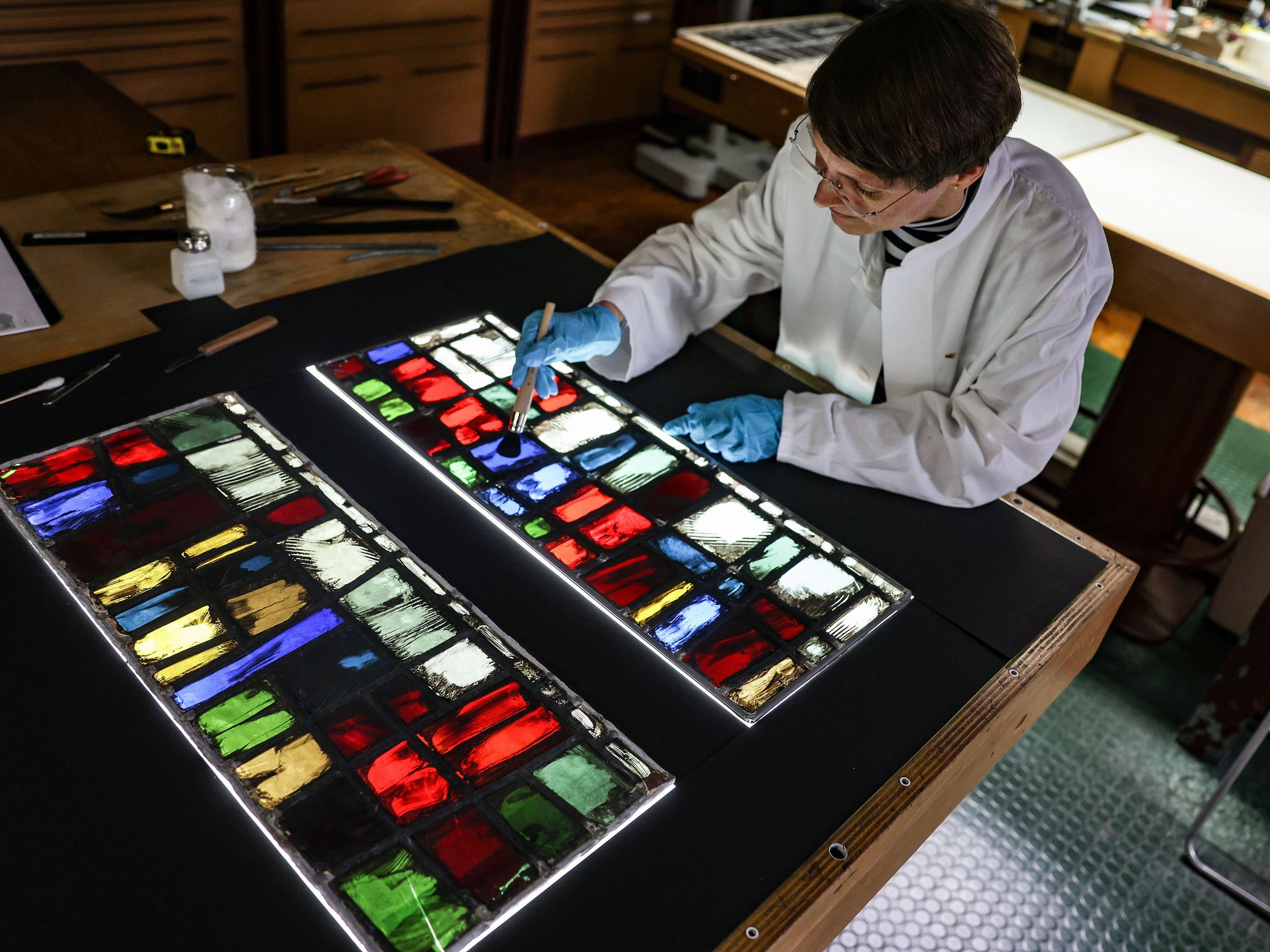Katrin Wittstadt, scientific director of the glass workshop at the Dombauhütte, works on stained glass windows from Notre Dame Cathedral.