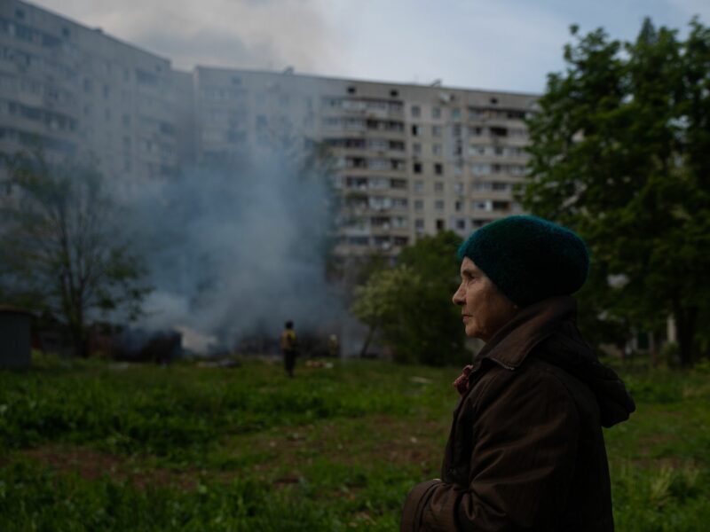 Kharkiv resident Valeria watches as crew extinguish a fire following a Russian strike.