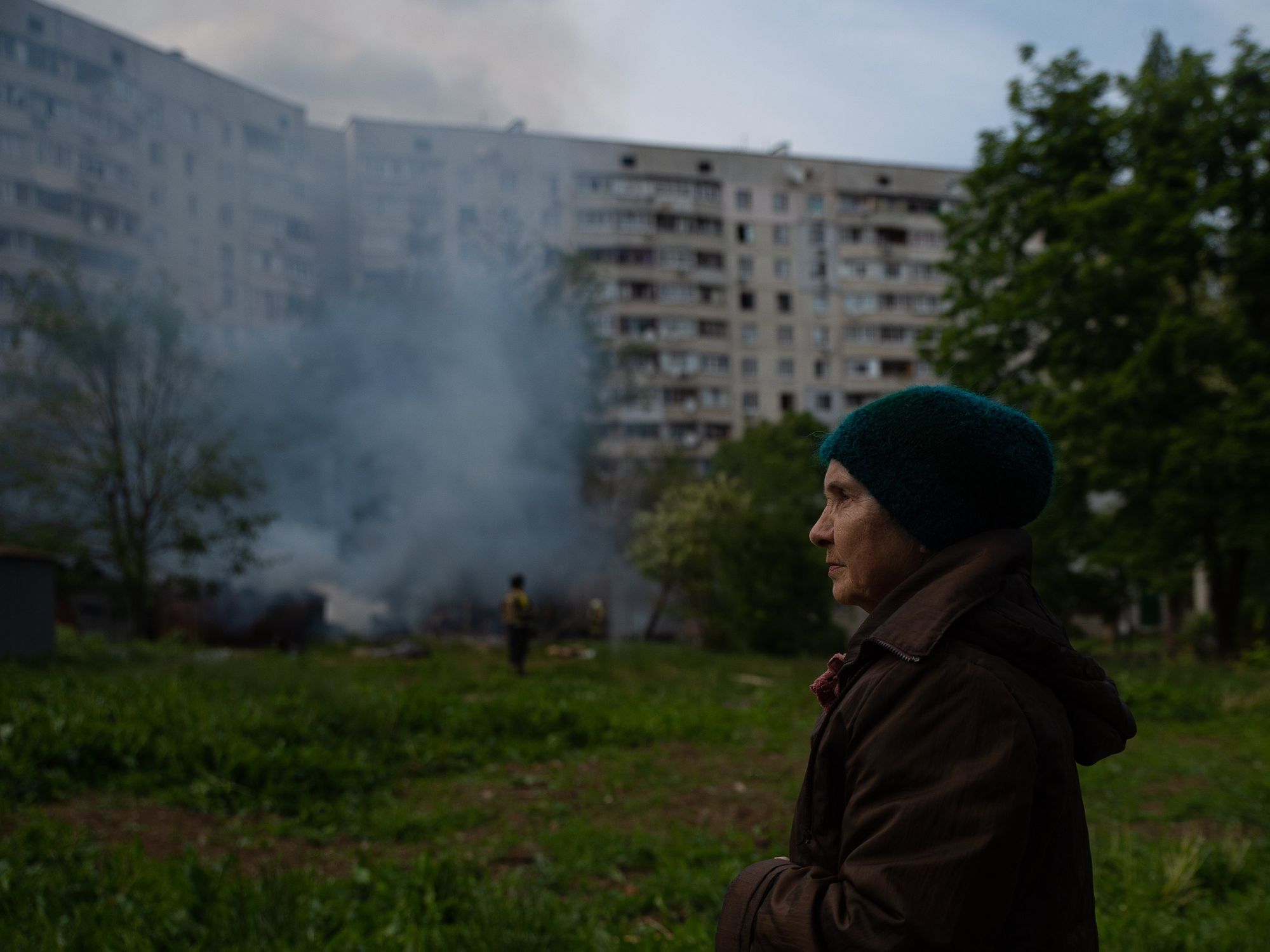 Kharkiv resident Valeria watches as crew extinguish a fire following a Russian strike.