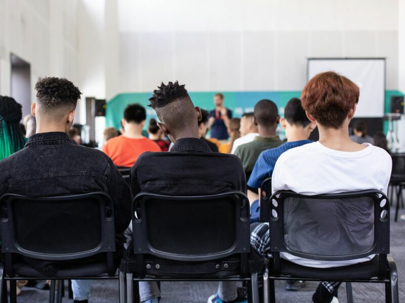 Kids sitting in the back of the classroom.​