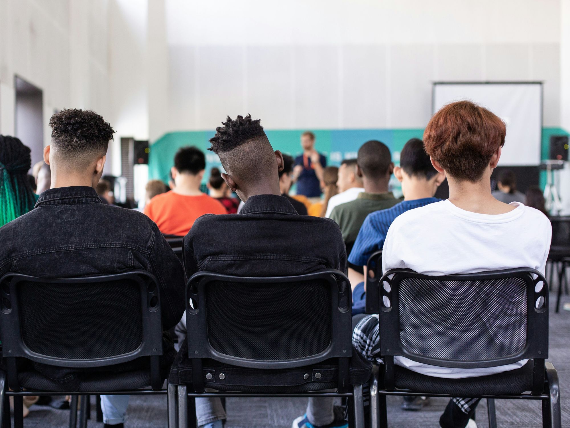 Kids sitting in the back of the classroom.​