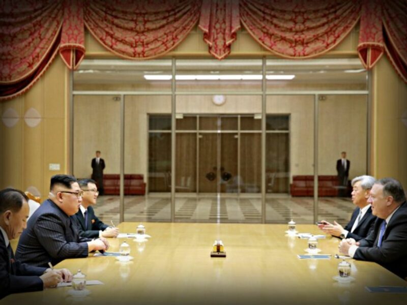 Kim across the table from U.S. Secretary of State Mike Pompeo in Pyongyang.