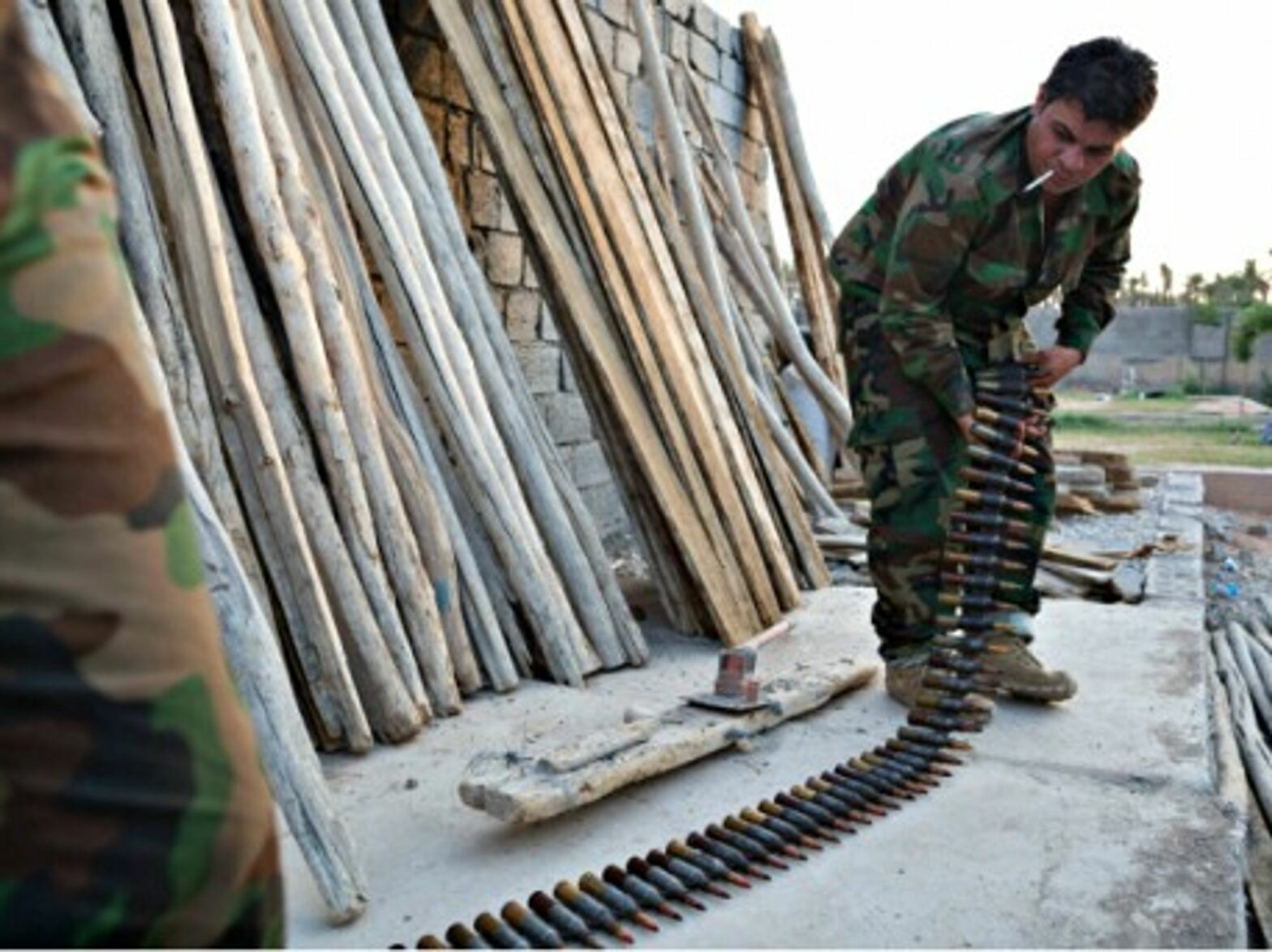 Kurdish peshmerga fighters prepare ammunition for a heavy machine gun at a base in Khanaqin, Iraq.