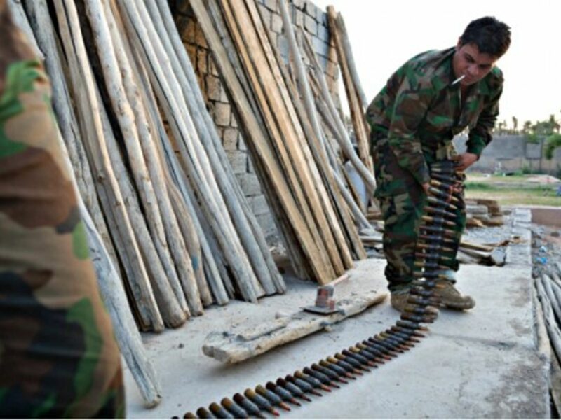 Kurdish peshmerga fighters prepare ammunition for a heavy machine gun at a base in Khanaqin, Iraq.