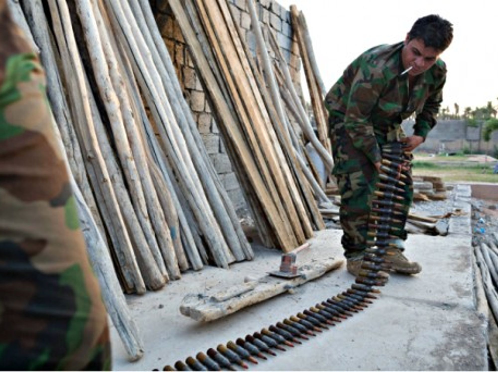 Kurdish peshmerga fighters prepare ammunition for a heavy machine gun at a base in Khanaqin, Iraq.