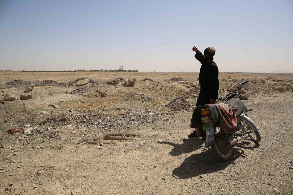 Laal Mohammed points to the location by Kandahar airfield where he says the tankers used to dump sewage and trash once or twice a week.