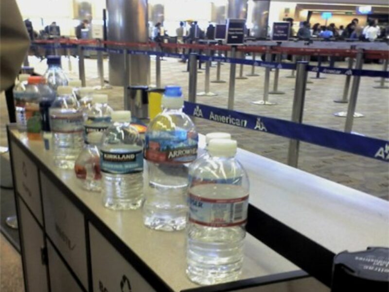 Left-behind water bottles have become common airport scenery (chelzerman)