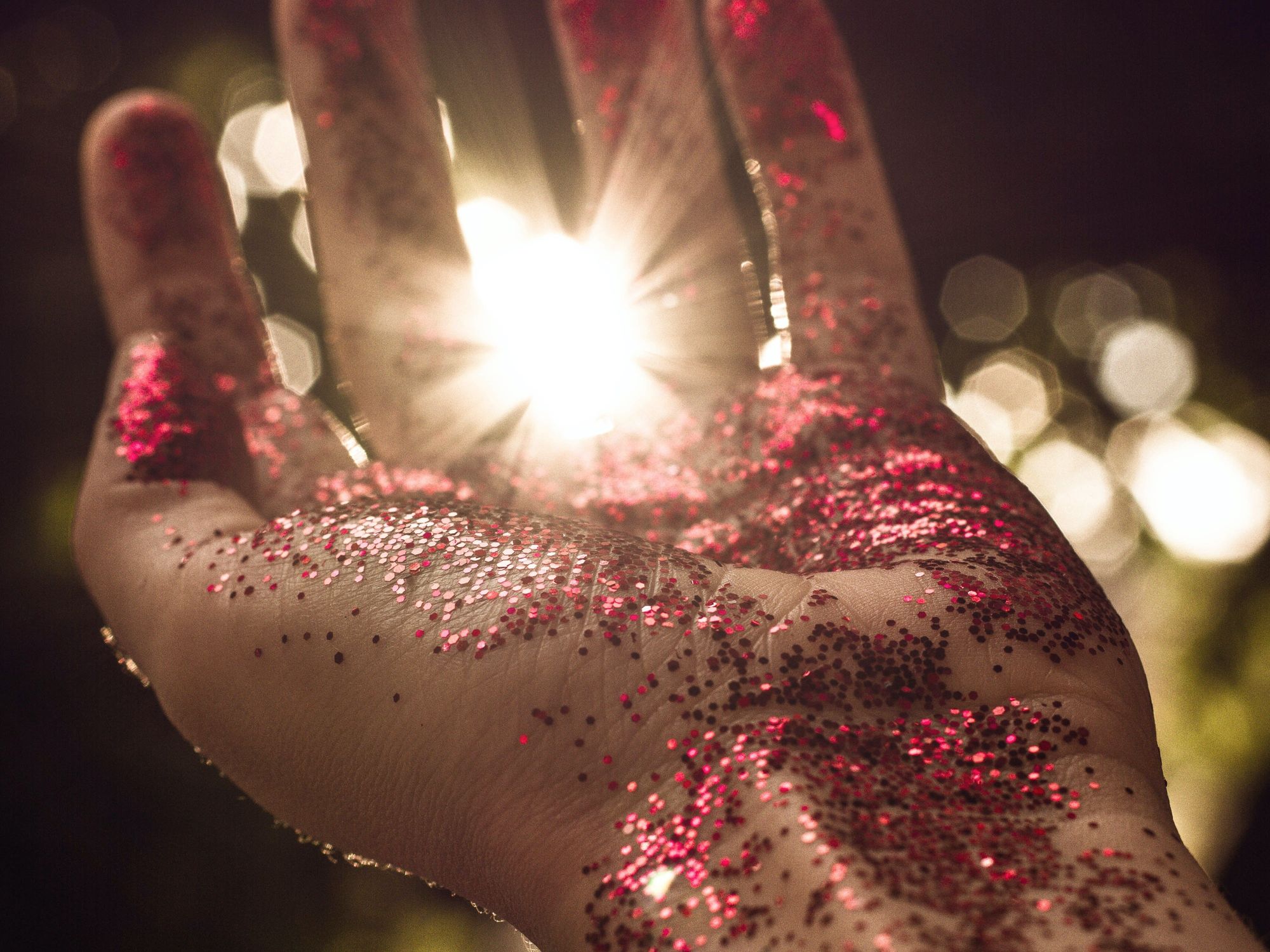 Left hand covered in red glitter