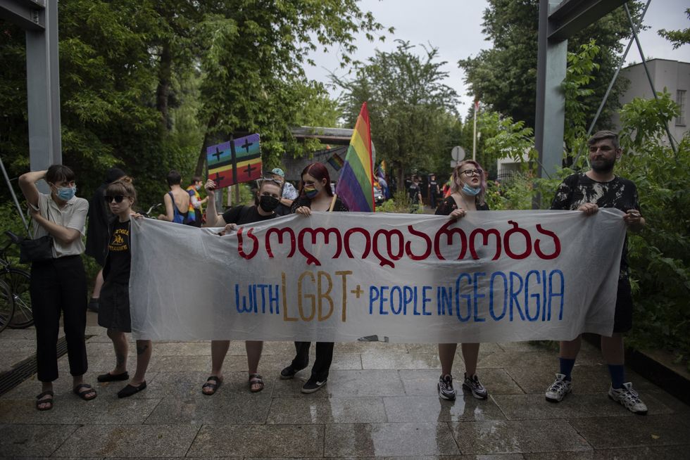 LGBT activists hold a banner next to the Georgian embassy to show solidarity with the Georgian LGBT+ community.
