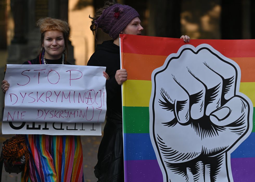 LGBT activits hold signs during a protest against "facism and transphobia" at the Jagiellonian University Collegium Witkowski in Krakow, 2022.