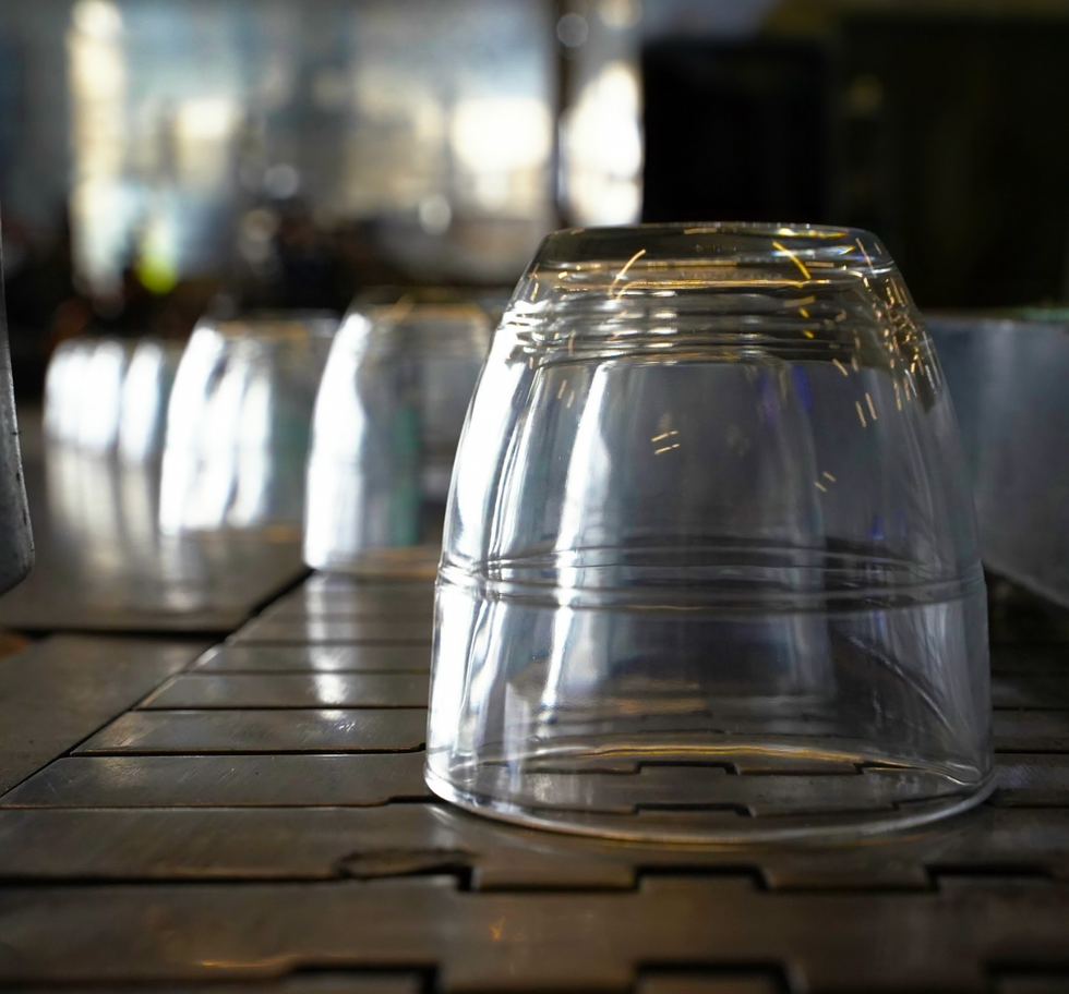Line of transparent glasses on table, ​"Each Duralex glass made in France generates 58% less CO2 emissions than an imported glass" says Duralex on its official Instagram account.