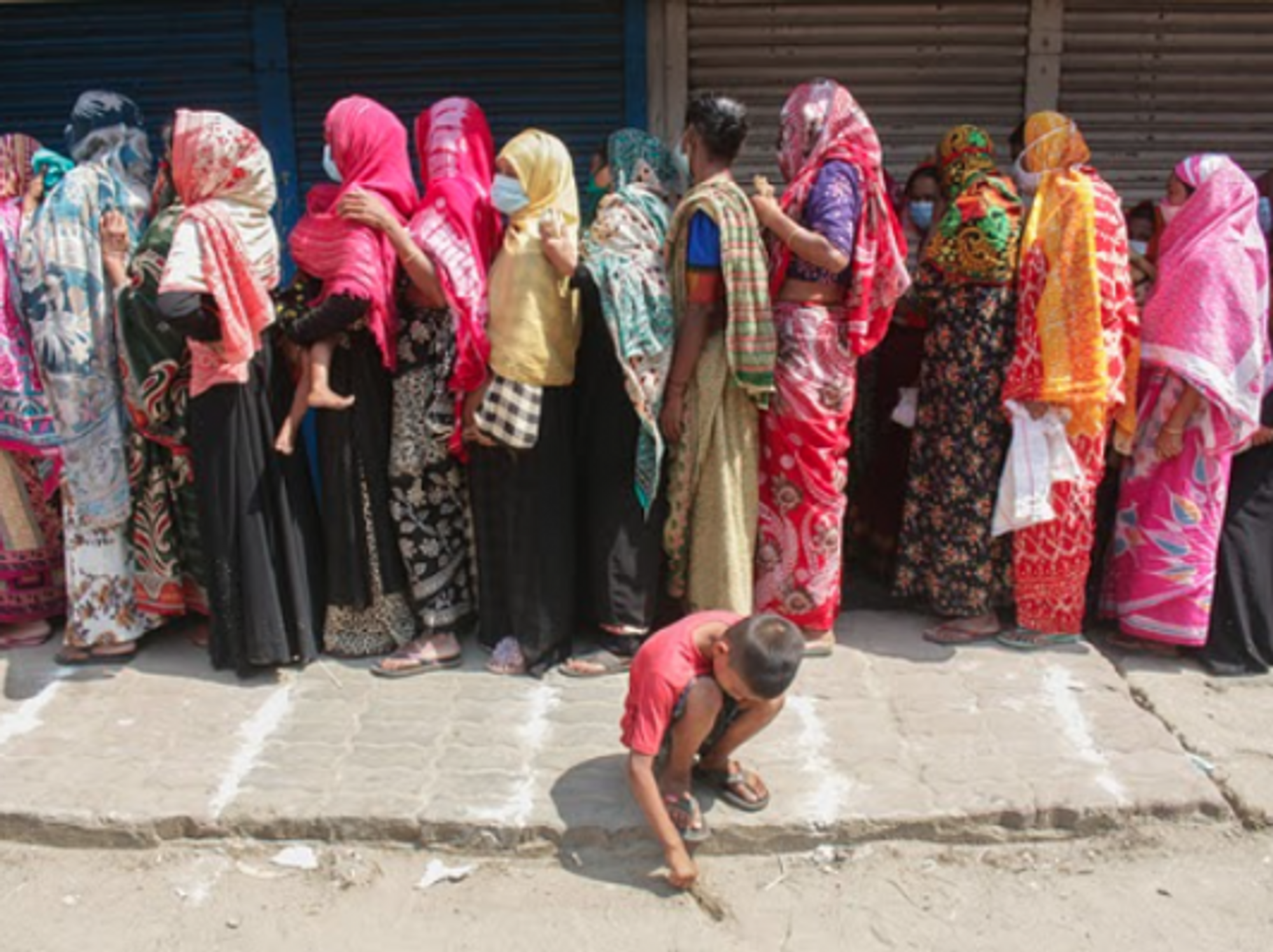 Lining up to buy rice and flour in Sylhet, Bangladesh as the country starts a 7-day lockdown.