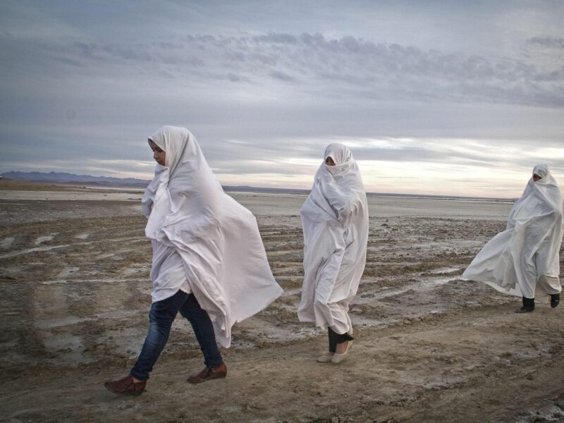 Local women walk on Gavkhooni wetland in Isfahan province, central Iran