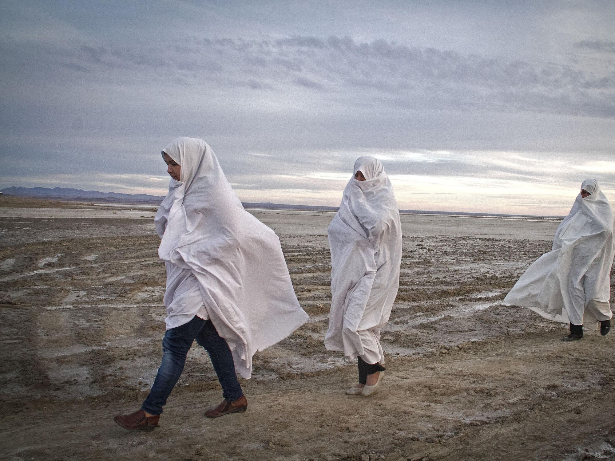 Local women walk on Gavkhooni wetland in Isfahan province, central Iran