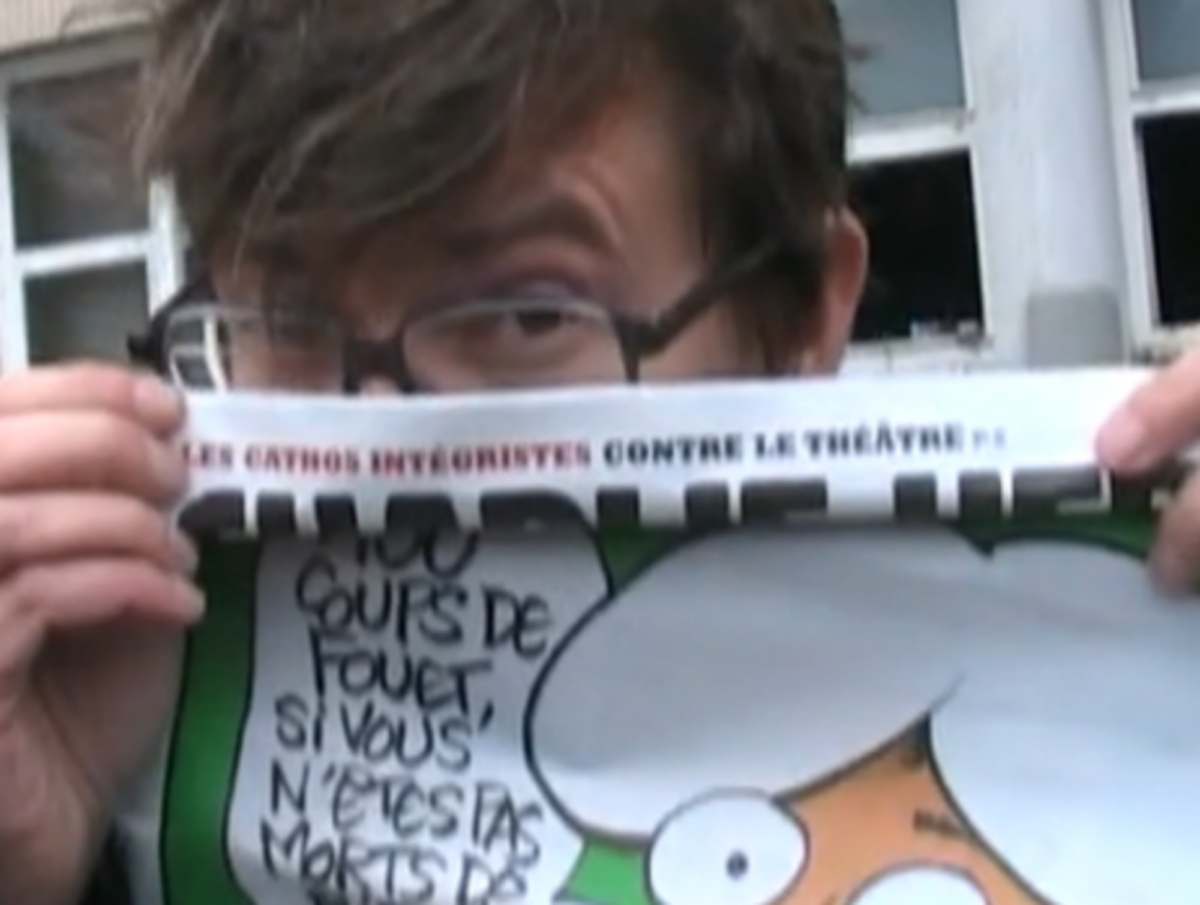 Luz, a Charlie Hebdo cartoonist, with Mohammed cover, outside magazine's firebombed offices (Rue89)