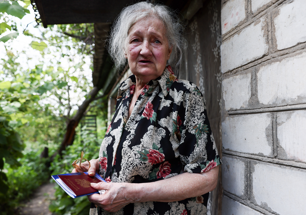 Lyudmila Bondarenko, an elderly woman with reduced mobility, has her Russian passport delivered to her home in the rural town of Stanitsa Luganskaya.