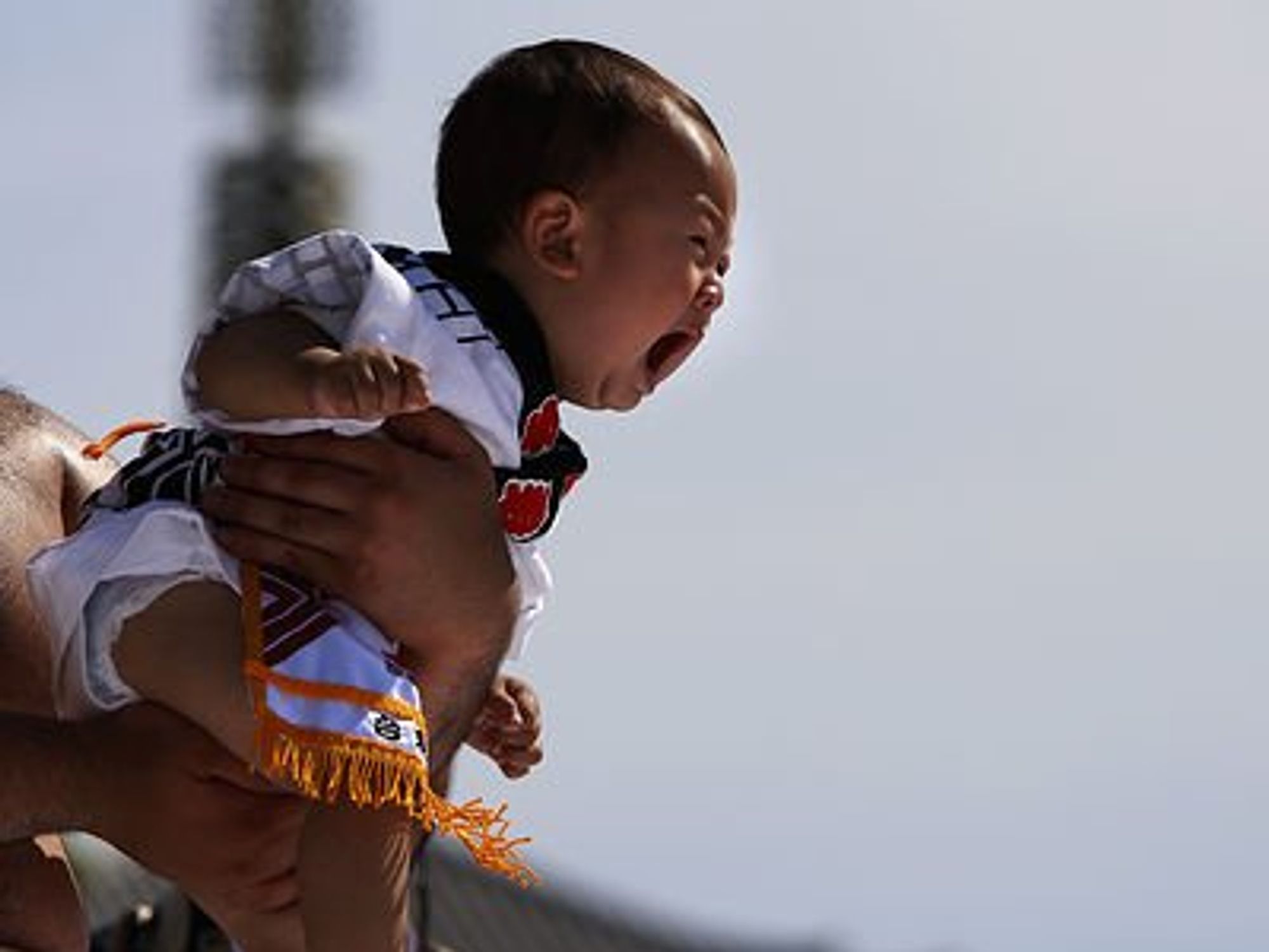 Man holding a baby crying.