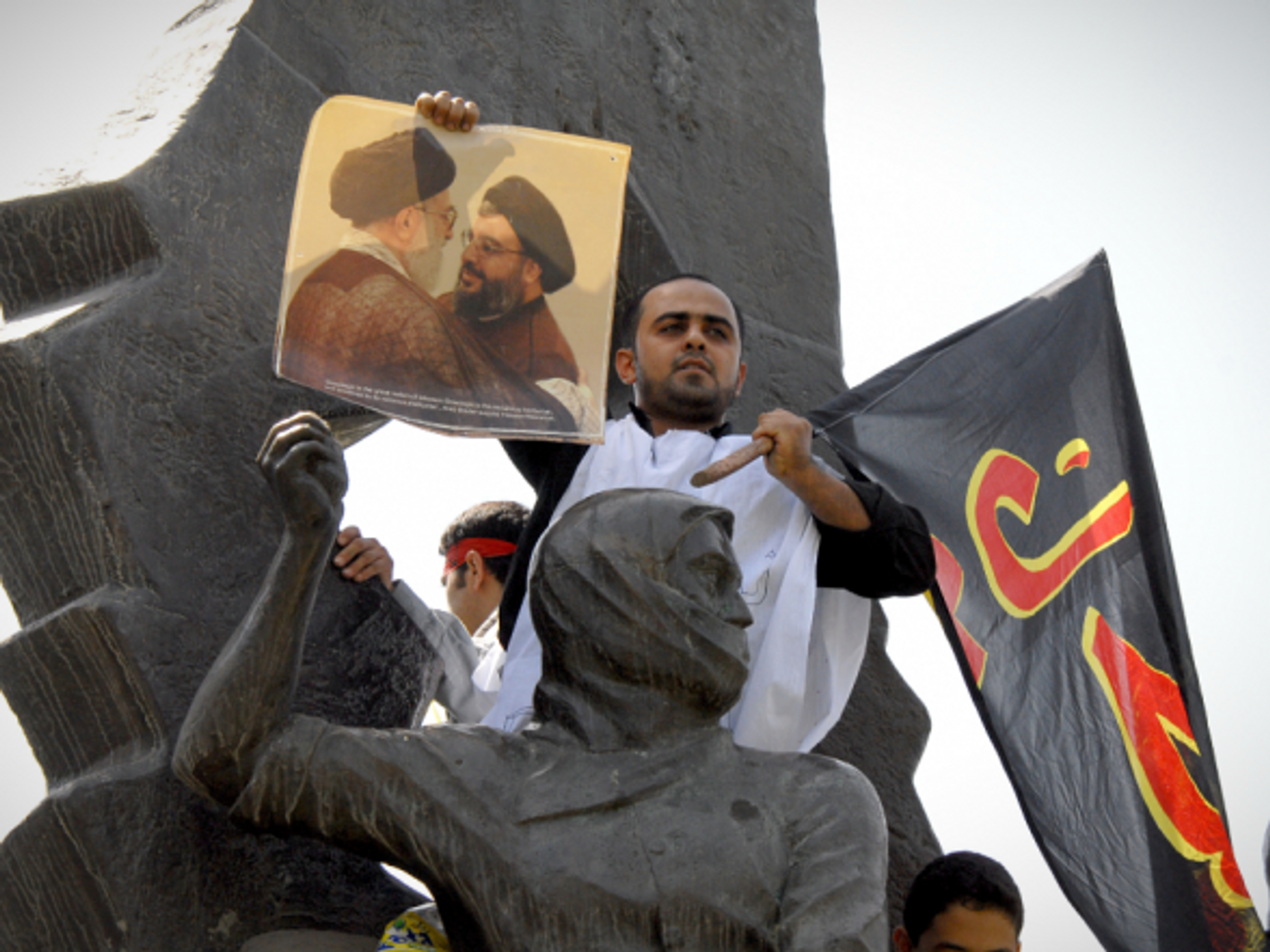 Man holding a poster of Iran Supreme Leader Khamenei & Hezbollah Sec. Gen. Nasrallah during a June 2007 protests in Tehran
