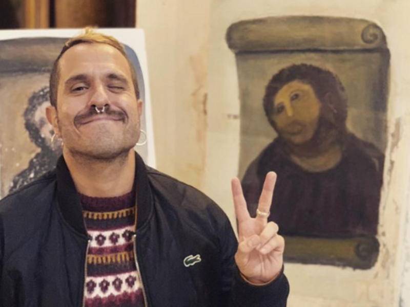 Man in front of the notorious disfigured Christ mural inside a chapel in Borja​