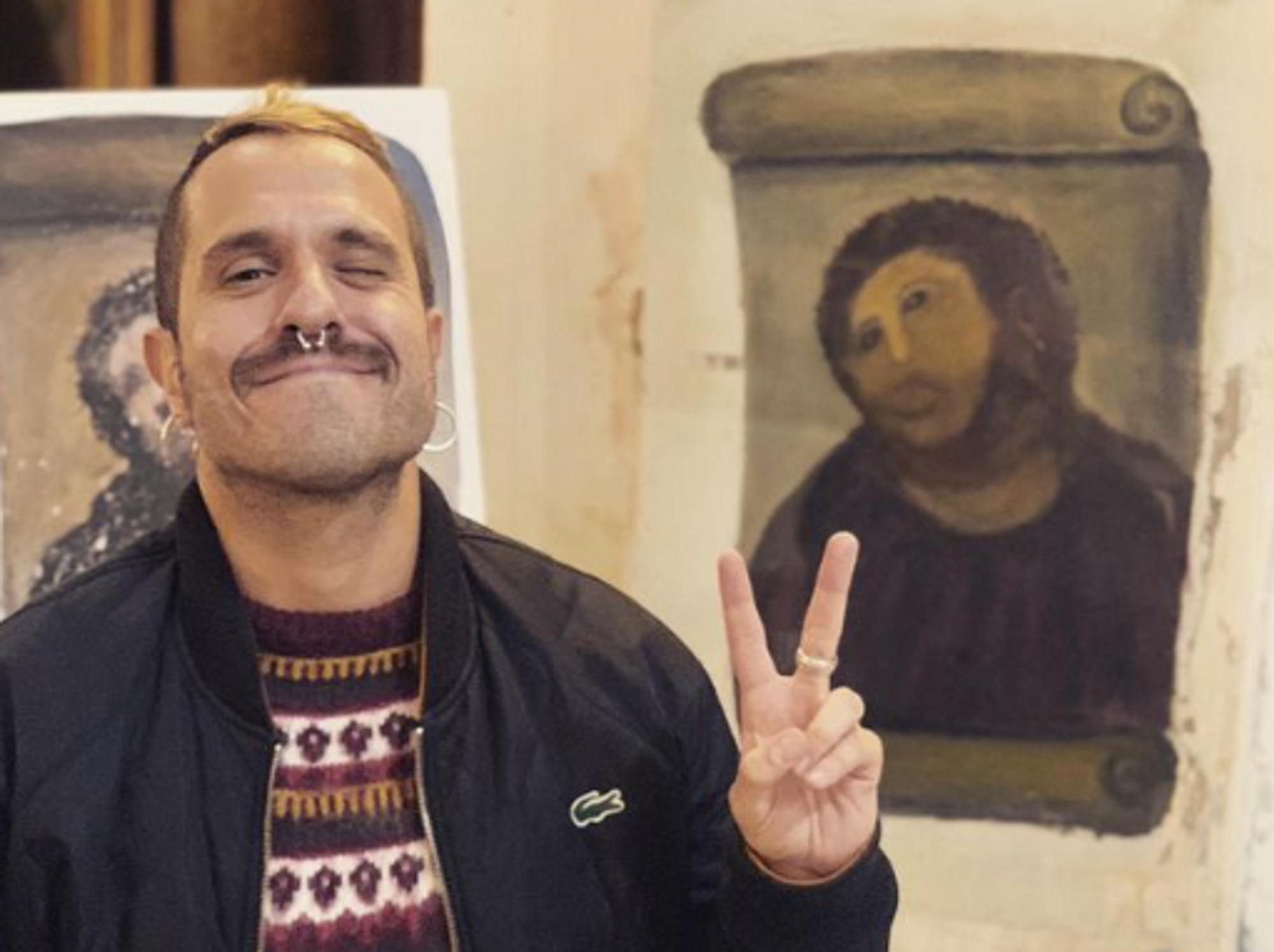 Man in front of the notorious disfigured Christ mural inside a chapel in Borja​