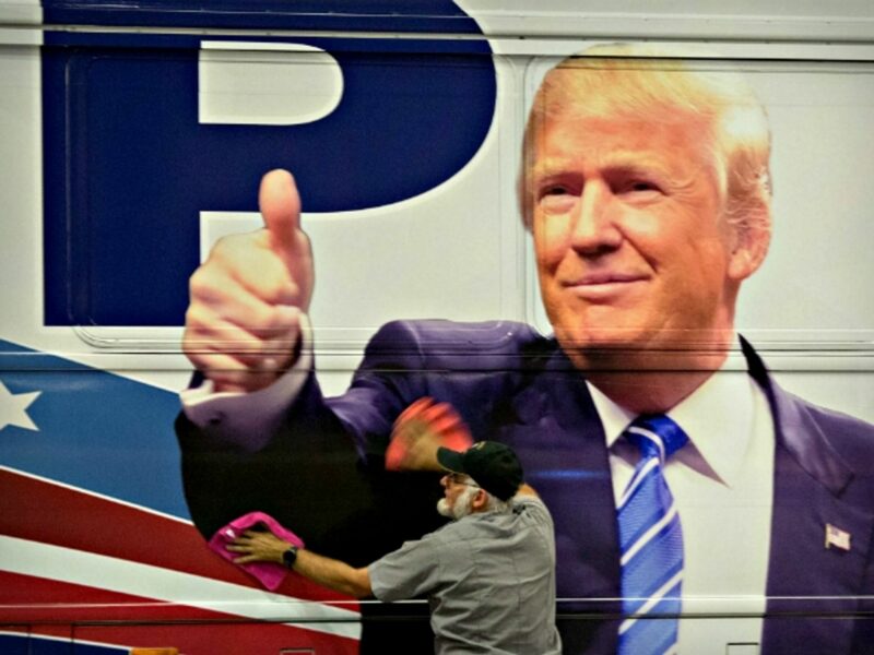 Man polishing a Trump campaign bus in Florida on Oct. 13