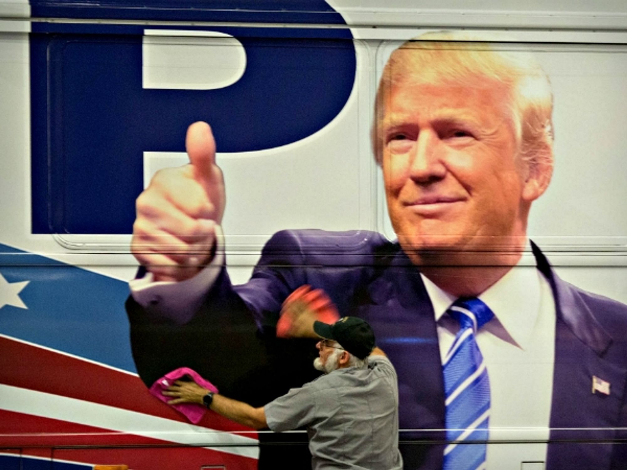 Man polishing a Trump campaign bus in Florida on Oct. 13