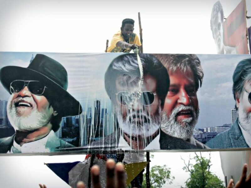 Man ritually pouring milk on a Rajinikanth poster in Chennai on July 22