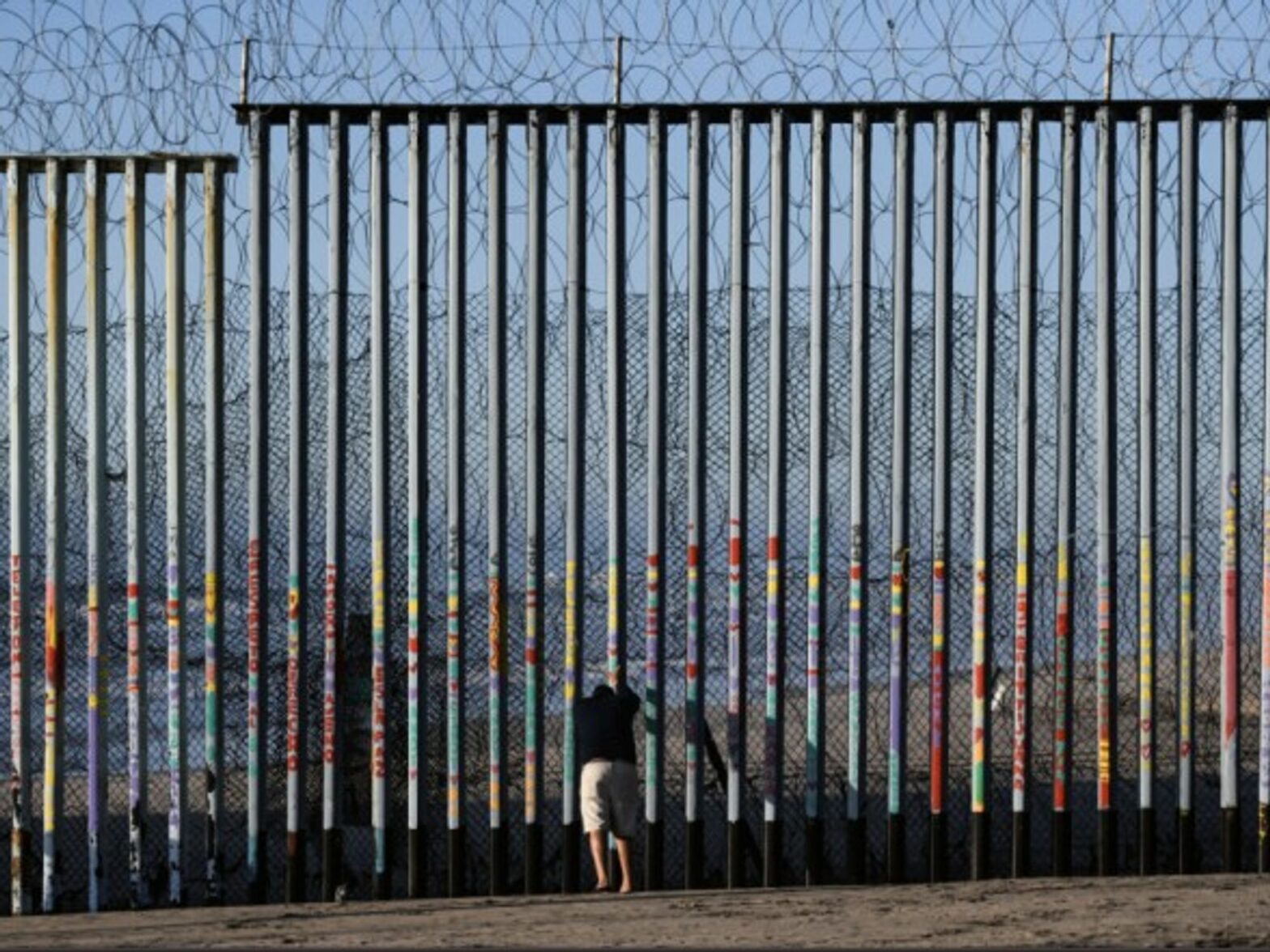 Man standing at the U.S - Mexico border in Tijuana, Mexico