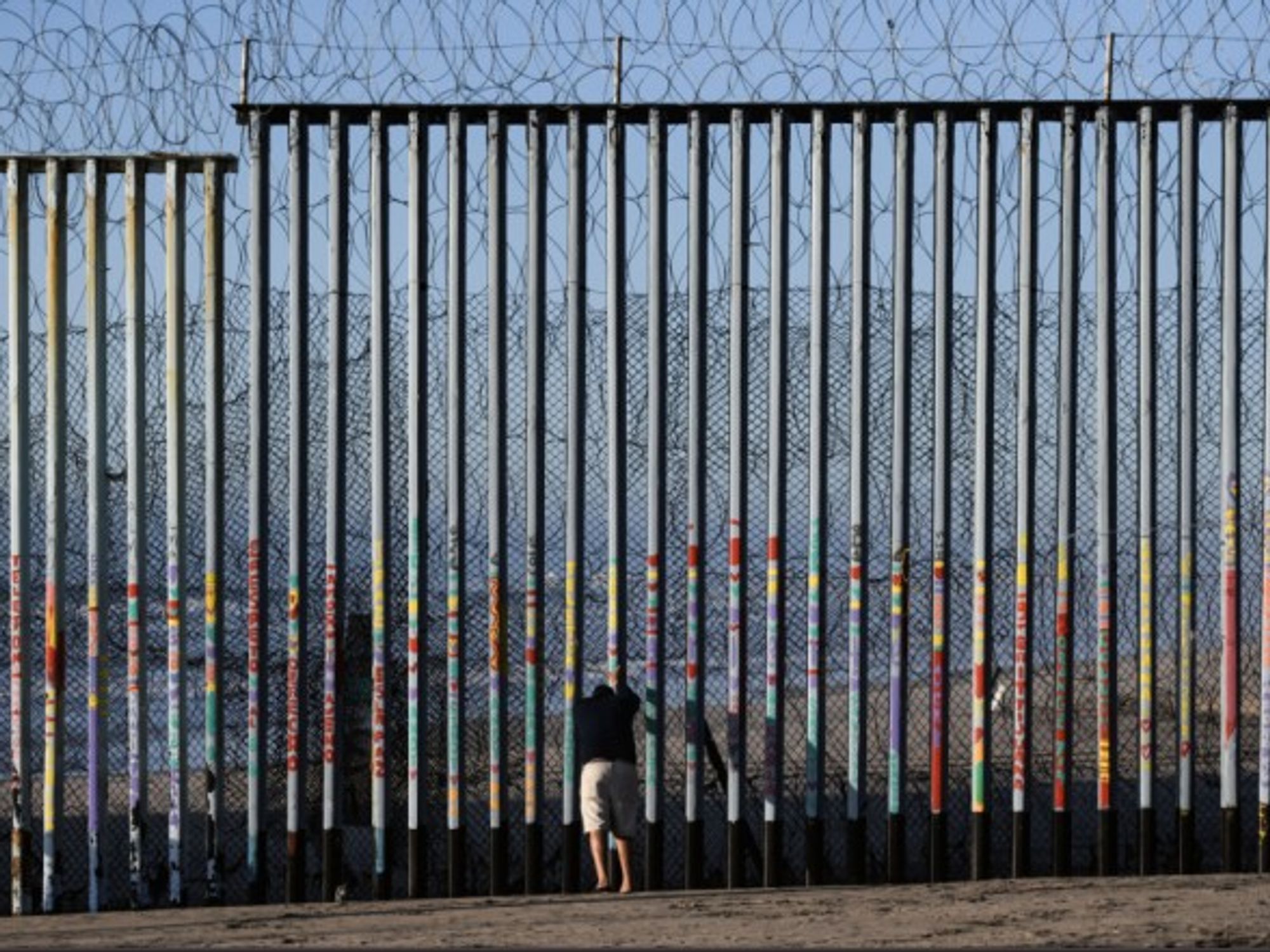 Man standing at the U.S - Mexico border in Tijuana, Mexico