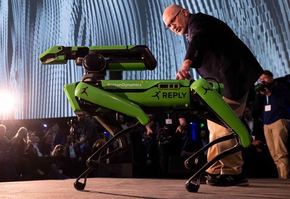 Marc Raibert, Chairman of Boston Dynamics presents a green "Spot" robot