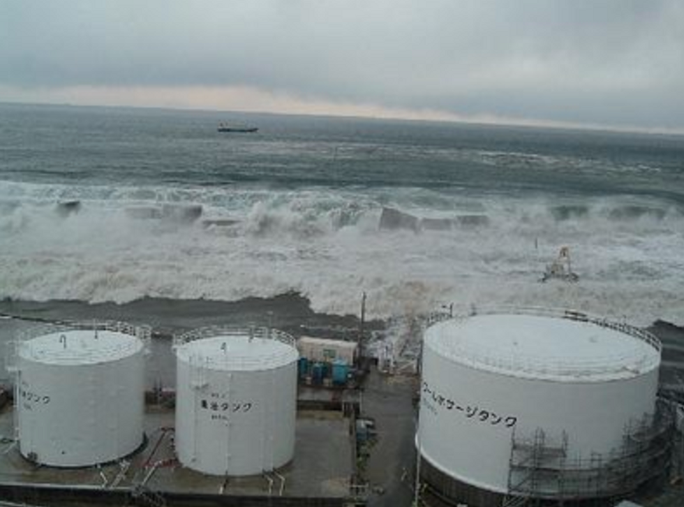 March 2011, Fukushima, Japan. This handout photo released by Tokyo Electric Power Company (TEPCO) shows the tsunami coming onto the slope at the eastern side of the Radioactive Solid Waste Storage Facility.