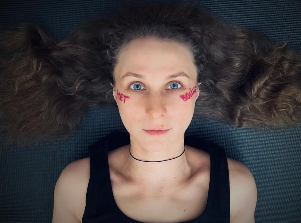 Maria Alyokhina with paint that reads "No to War"