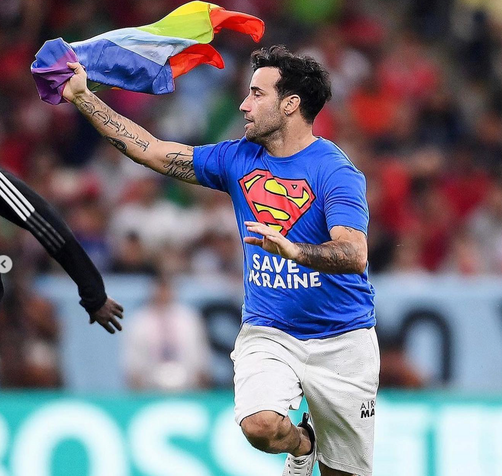 Mario Ferri waving a rainbow flag during the Portugal-Uruguay game.
