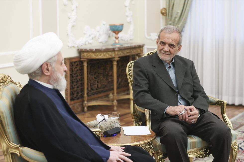 Masoud Pezeshkian and Naim Qassem seated and talking.
