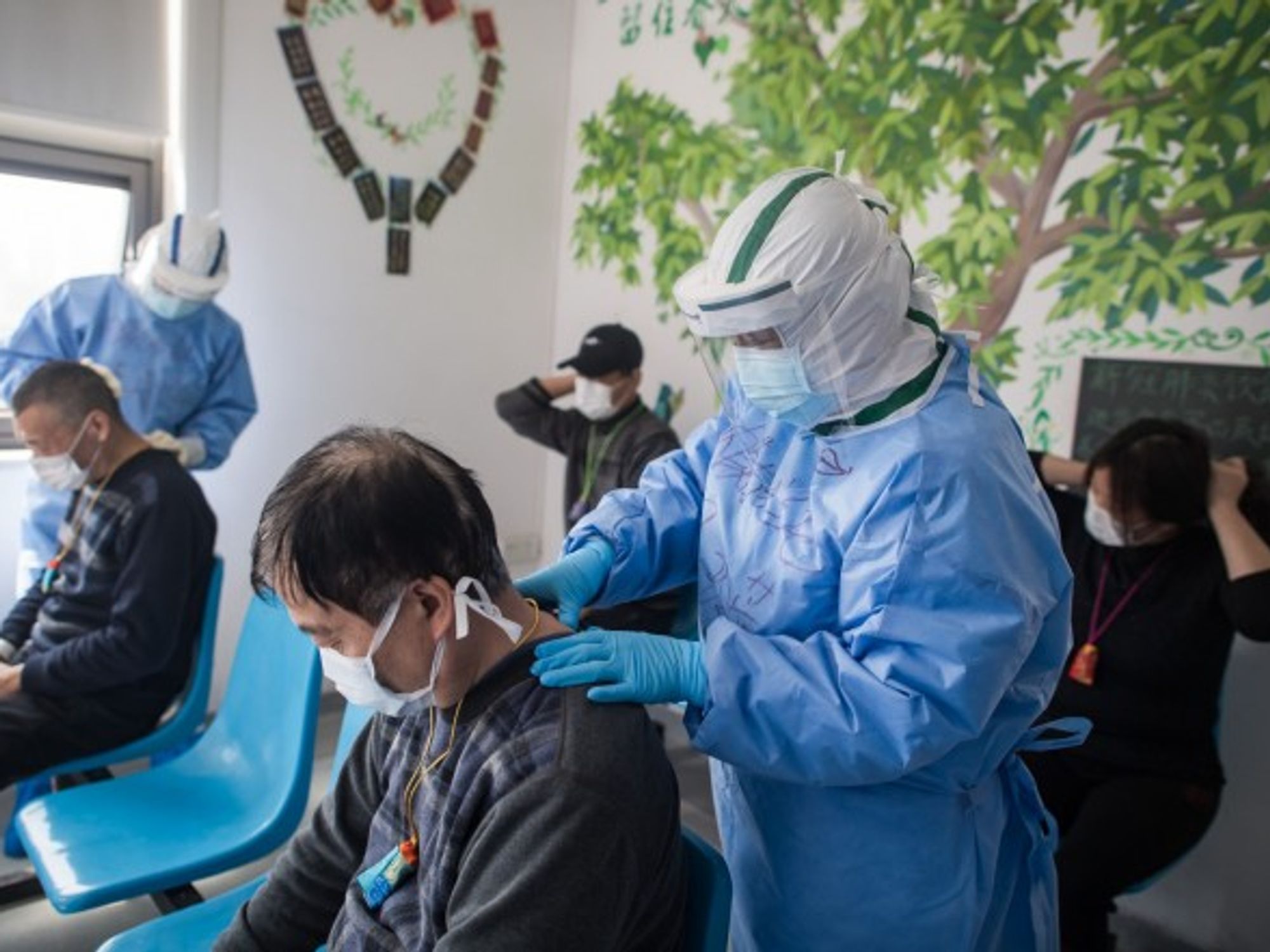 Medical workers in Wuhan massage patients' acupuncture points.