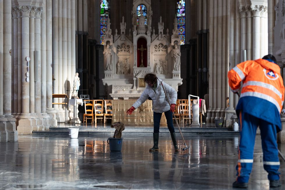 Members and volunteers of the Protection Civile clean a church affected by the floods, in Blendecques, in the Pas-de-Calais department, northern France