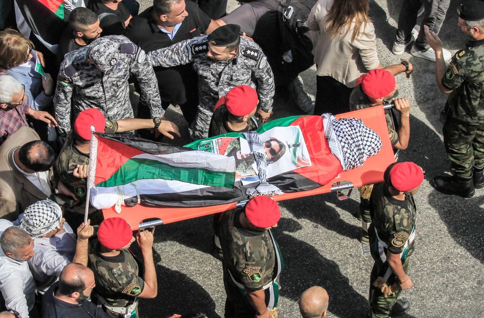 Members of Palestinian security forces carry the body of slain Turkish-American International Solidarity Movement activist Aysenur Ezgi Eygi during a funeral procession in Nablus in the occupied West Bank.
