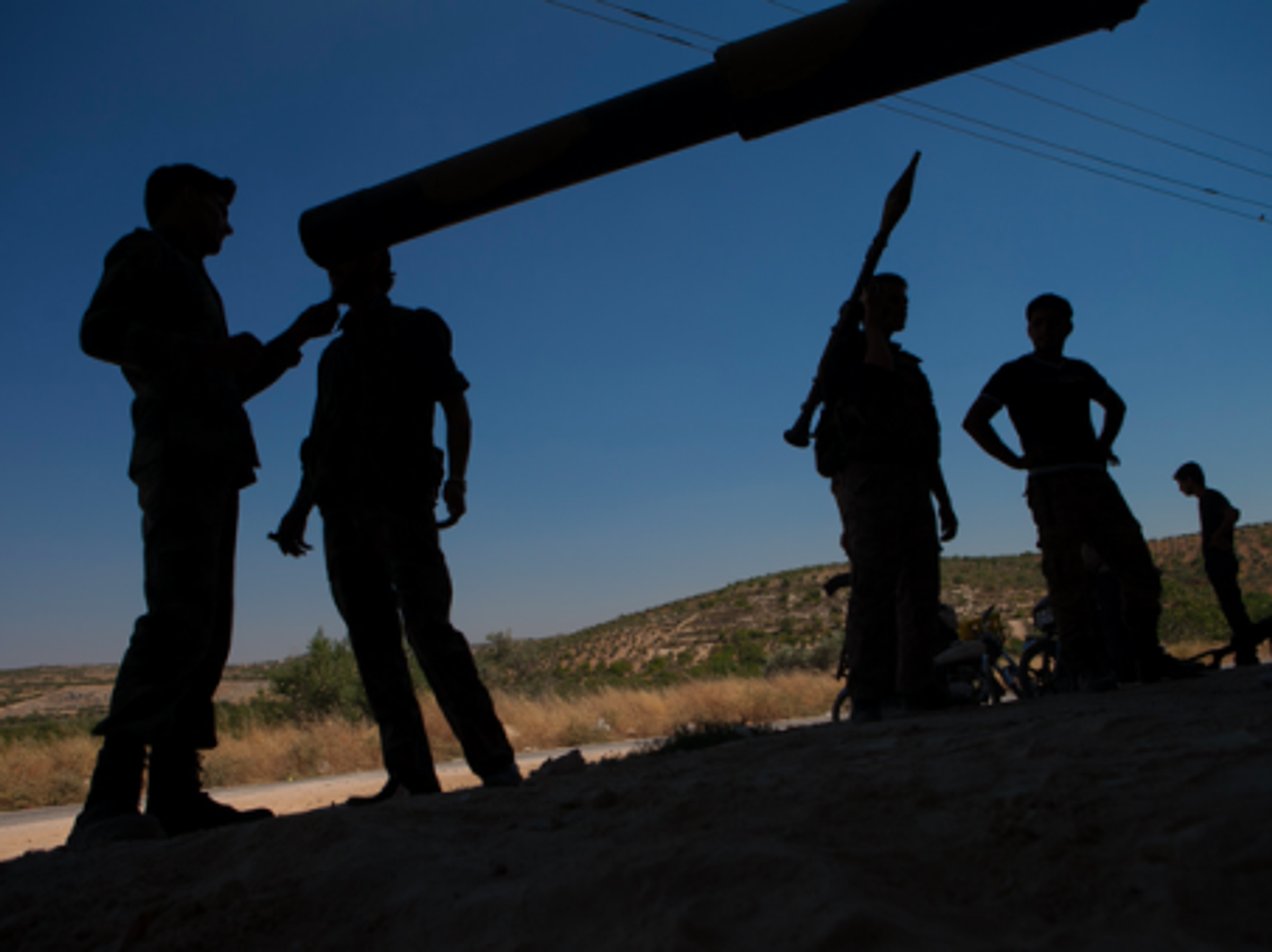 Members of the Free Syrian Army in front of a T-72 tank parked in a secret location in northern Syria.