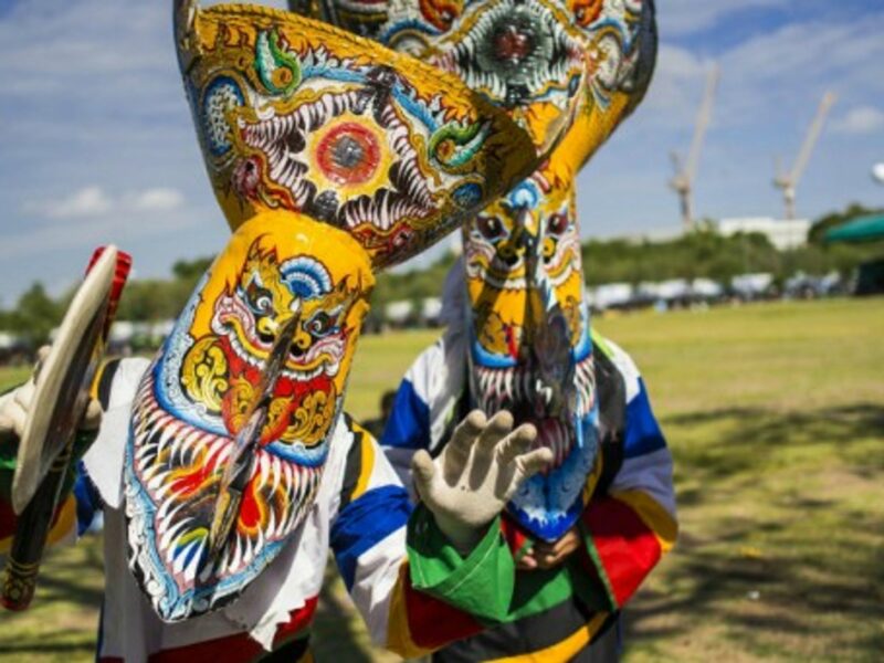 Men dressed as Phi Ta Khon take part in Bangkok's "happiness party" organized by the Thai military.