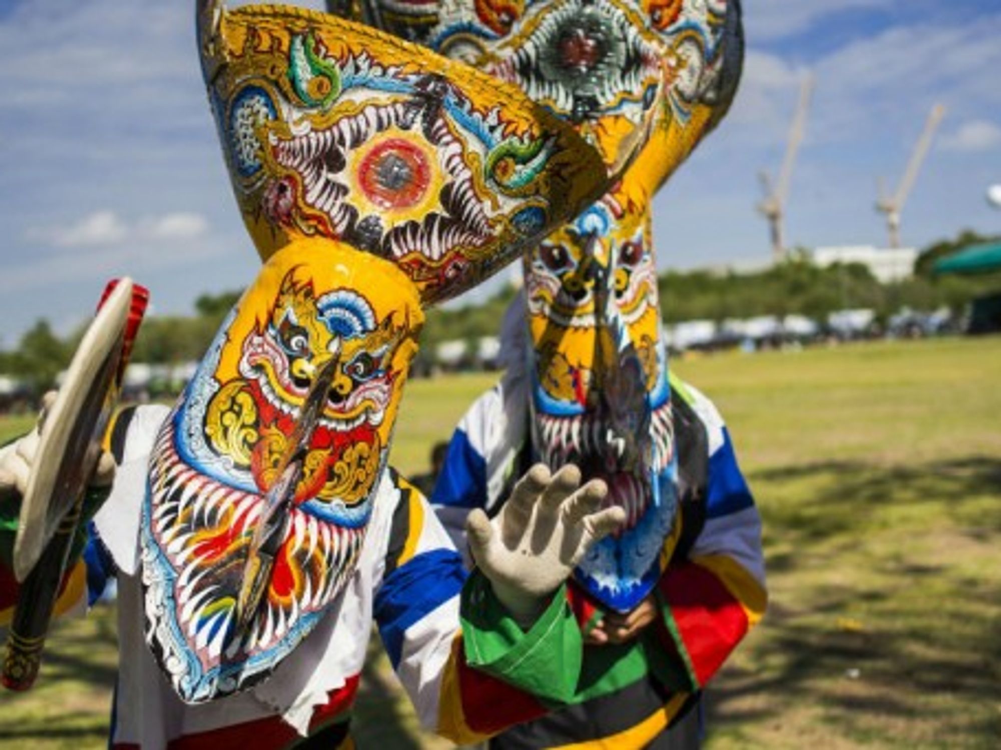 Men dressed as Phi Ta Khon take part in Bangkok's "happiness party" organized by the Thai military.