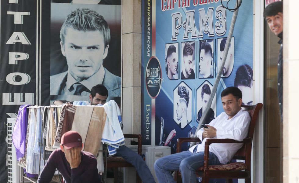 Men outside a barber shop in the town of Bokhtar, Khatlon Region.