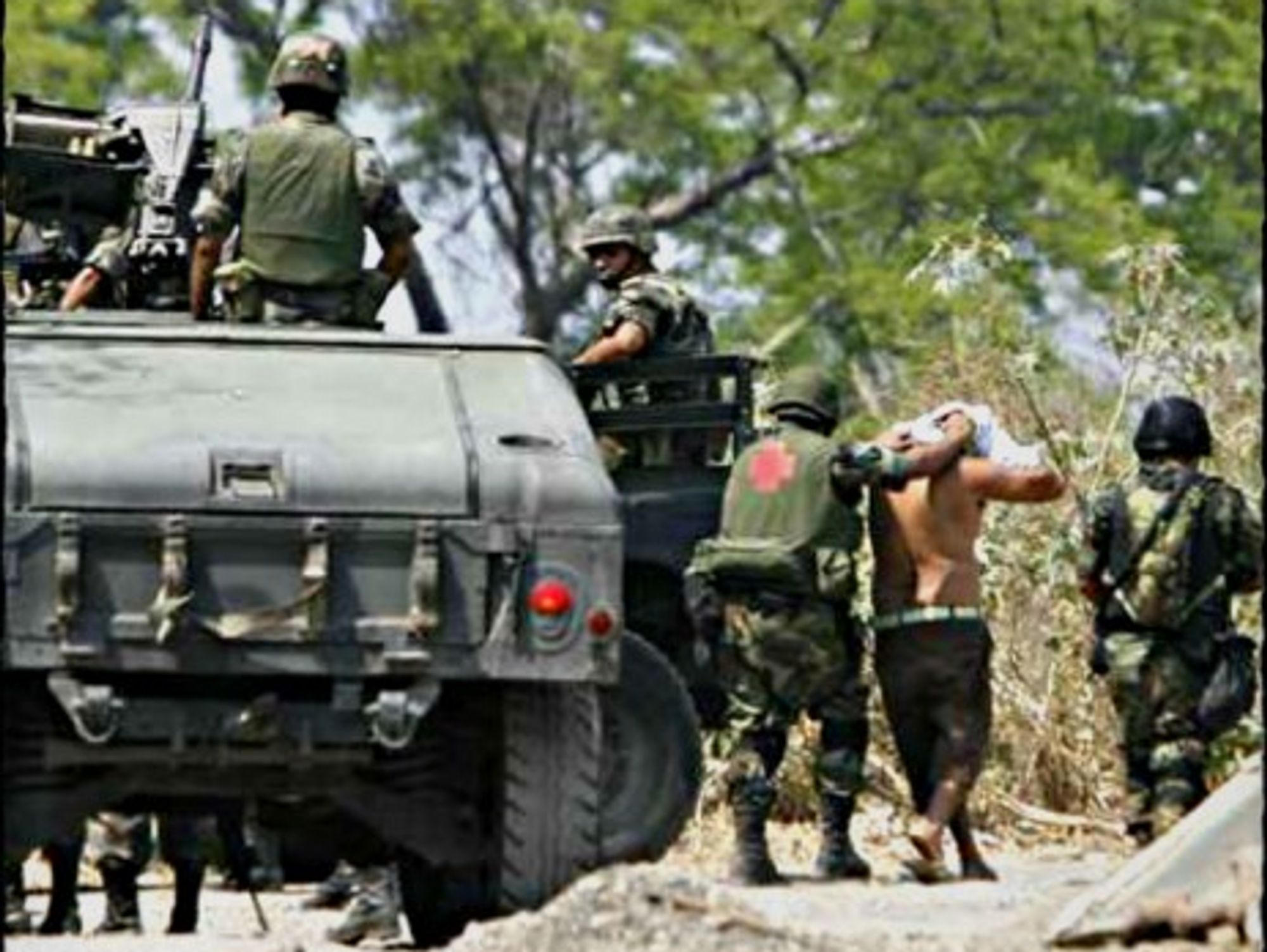 Mexican soldiers arresting cartel suspects in southwestern Mexico