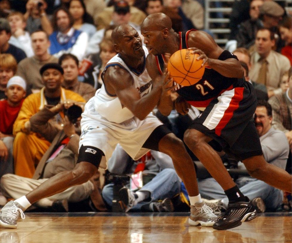 Michael Jordan, left, defends for the ball.
