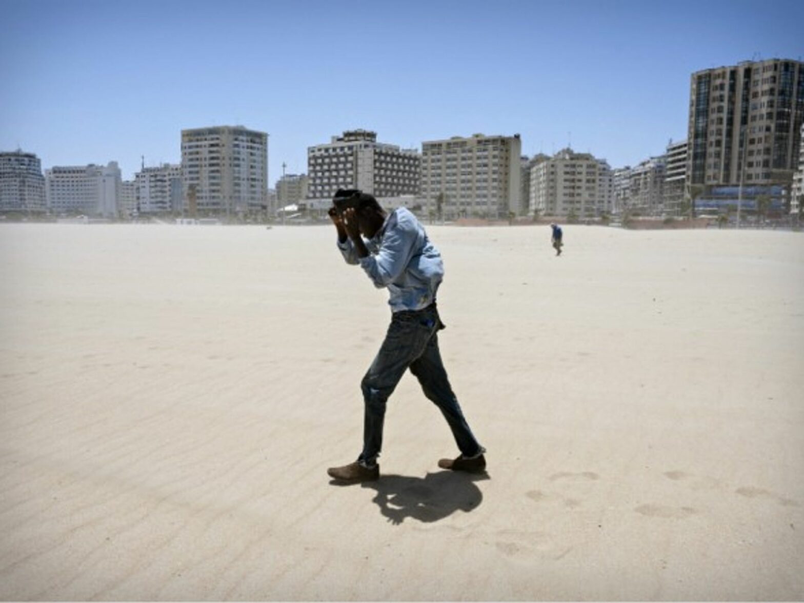 Migrant walking on a beach in Tangier, Morocco