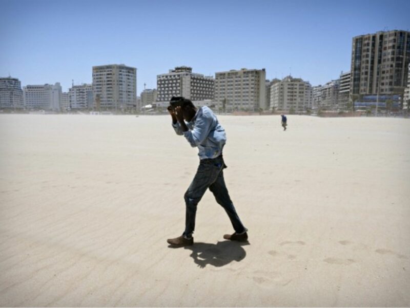 Migrant walking on a beach in Tangier, Morocco